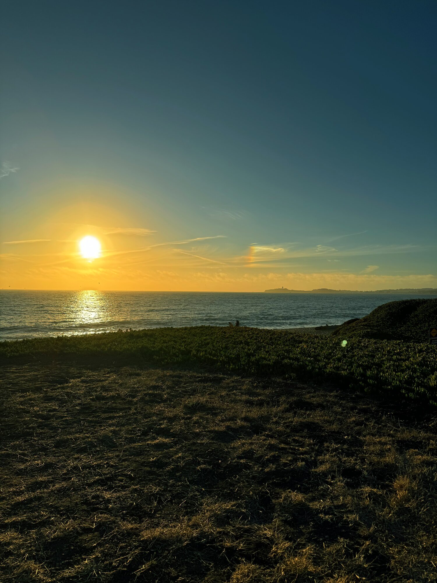 Sunset over the ocean from a coastal bluff